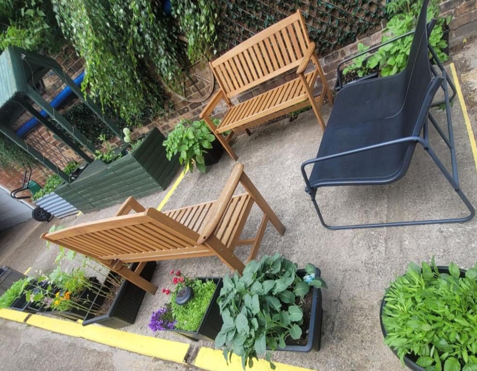 Outdoor seating and vegetable planters, tended by residents and our gardening volunteers.